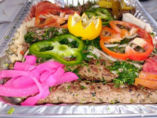 Juicy Shish Tawook Skewer marinated with garlic, lemon, and spices. Served with pita, fries, salad, and sauces. Taste authentic Middle Eastern flavor in London!